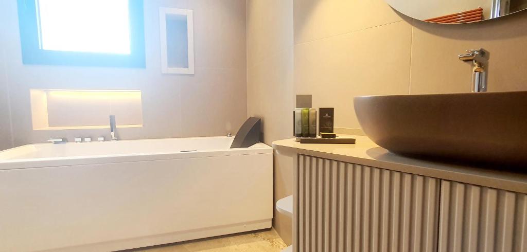 a bathroom with a sink and a toilet at Solmaris Tropea Rooms & Suites in Tropea