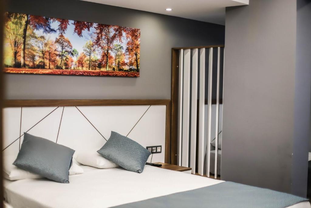 A bed or beds in a room at Hakcan Hotel