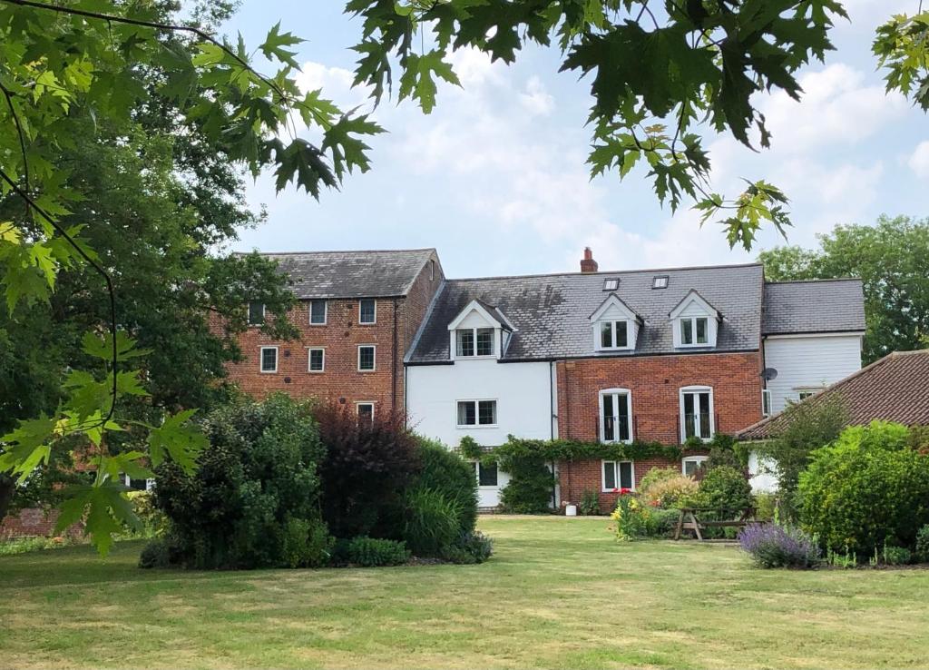 an exterior view of a house with a yard at Waterside, Elmham Watermill, Norfolk in North Elmham