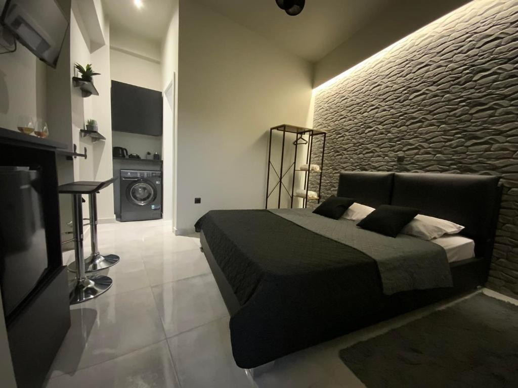 a bedroom with a bed and a television in it at I Love Home Mini in Kalamata