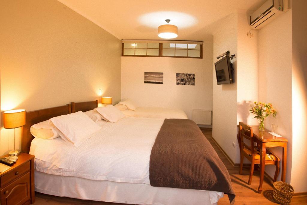 Postel nebo postele na pokoji v ubytování Hotel Loreto