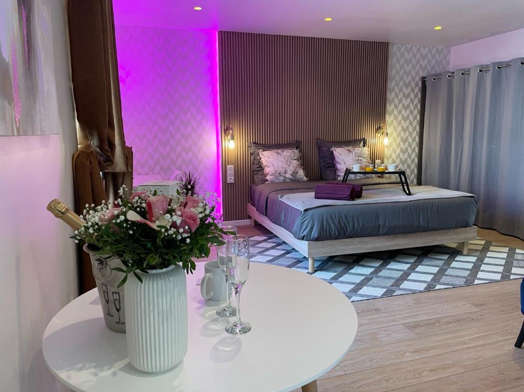 a bedroom with two beds and a table with flowers at Nice Renting - Love Room Massena - Luxe Room - Jacuzzi - Terrace - King Bed - AC in Nice