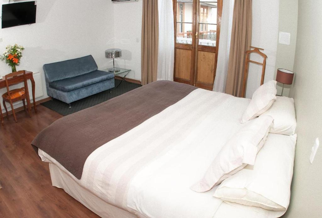 Postel nebo postele na pokoji v ubytování Hotel Loreto