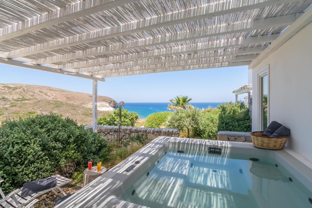 a swimming pool in a house with a pergola at Milos Breeze Boutique Hotel in Pollonia