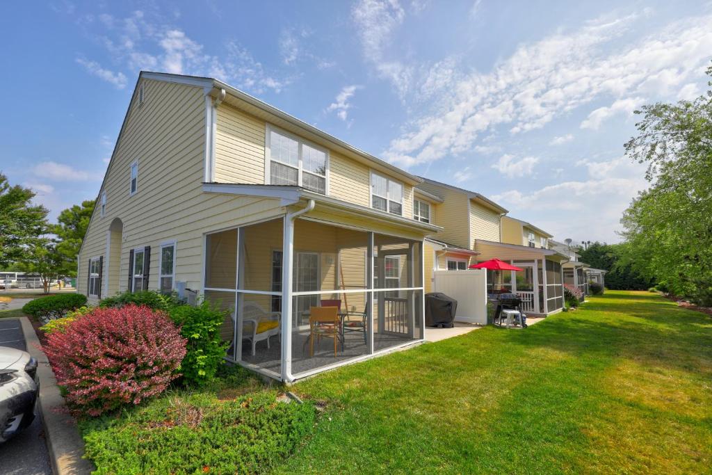 a house with a lawn in front of it at Keys of Marsh Harbor Truman Ct in Rehoboth Beach