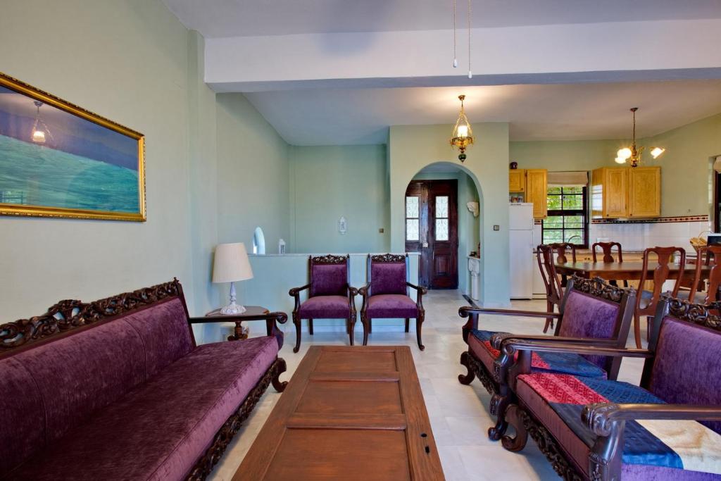 a living room with couches and chairs and a table at Vintage country house in Halkidiki in Nea Fokea