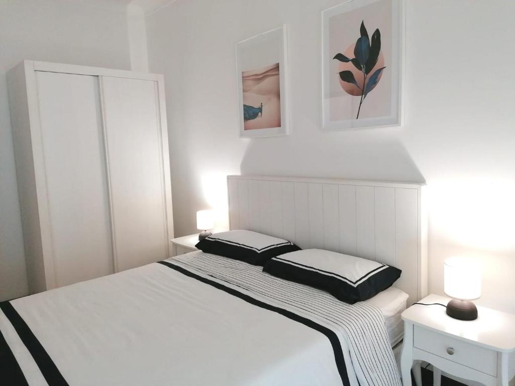 a bed with two pillows on top of it in a bedroom at B in Caminha in Caminha