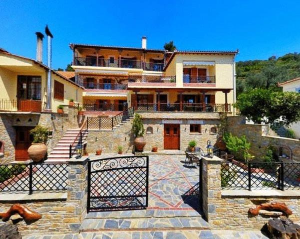 a large house with a gate in front of it at Ikosimo Guesthouse in Milina