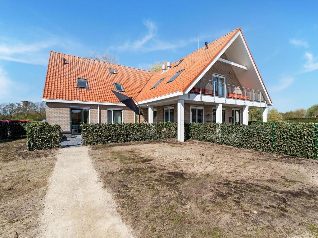 a large house with an orange roof at Island Retreat for Families in Nes