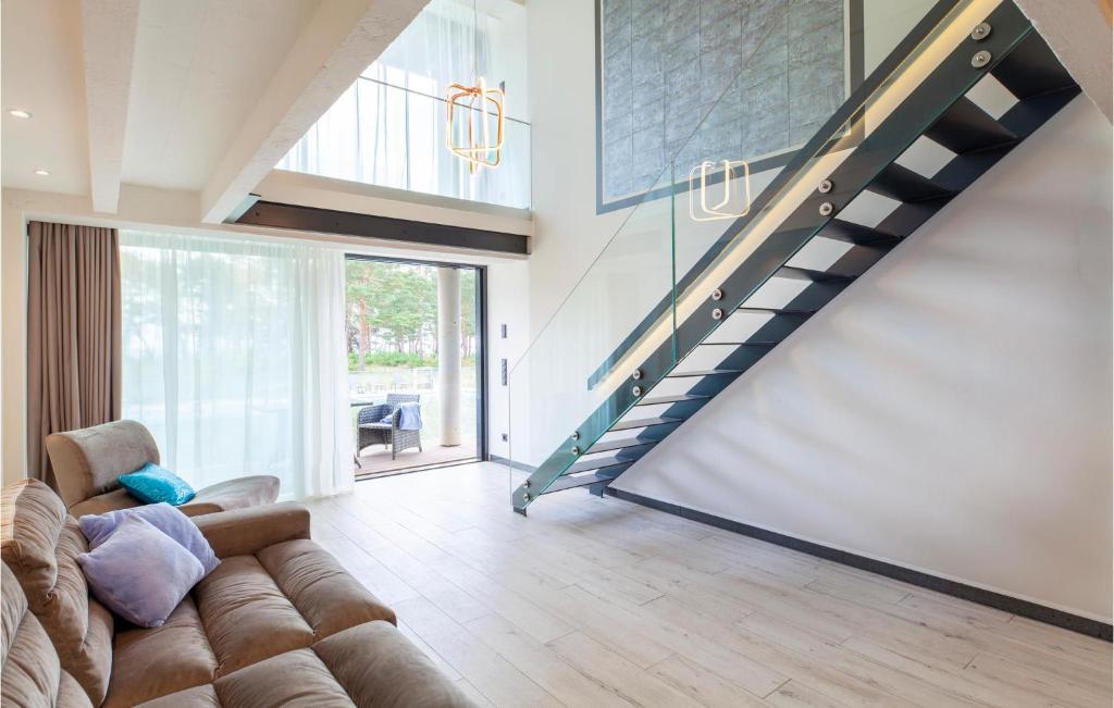 a living room with a couch and a staircase at Prora Solitaire Avida Loft 9 in Binz
