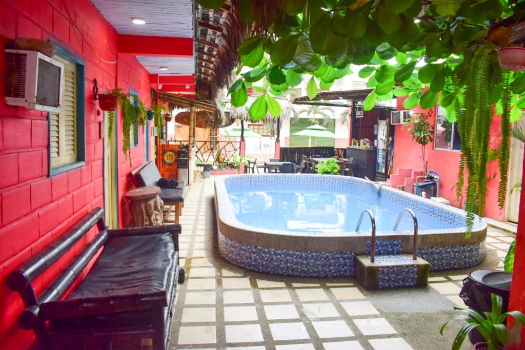 a hot tub on a patio next to a building at Arrecife Montañita Hostal in Montañita