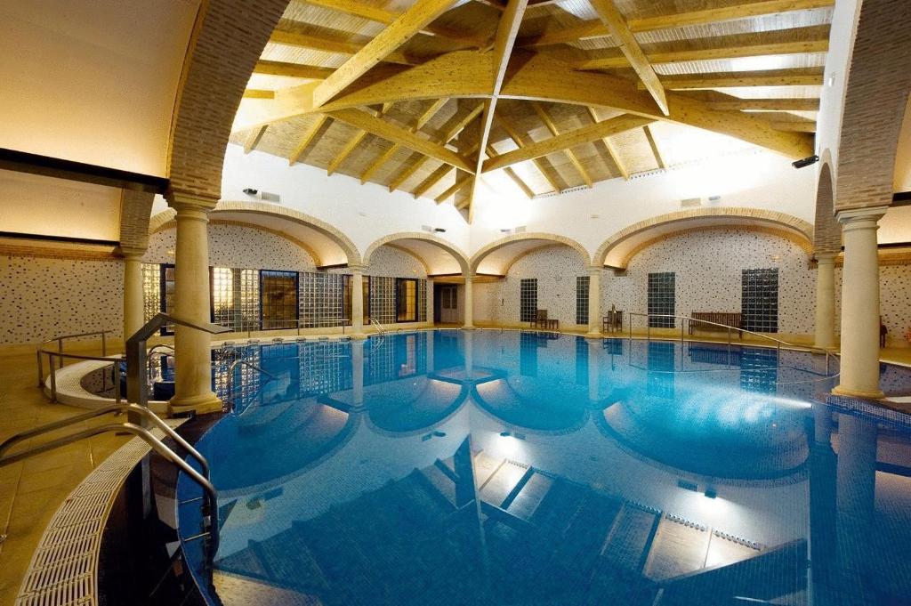 a large indoor swimming pool in a building at Balneario Cervantes in Santa Cruz de Mudela