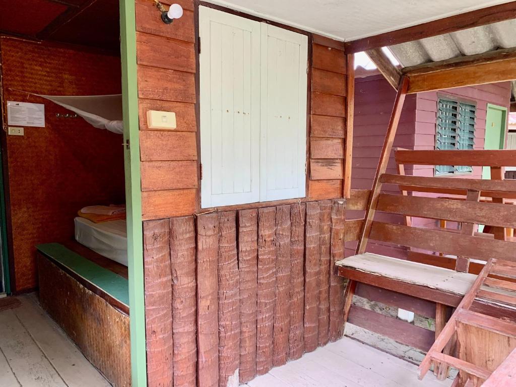 a room with a door and a window and a ladder at Beck's Resort in Haad Pleayleam