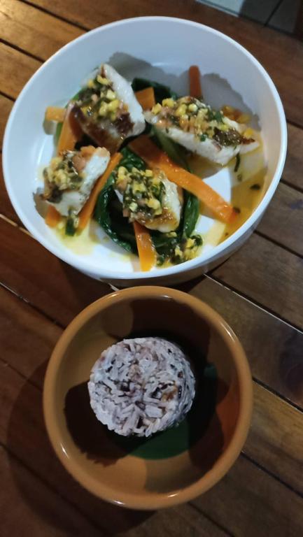 two plates of food on a wooden table at Tiki House in Bora Bora