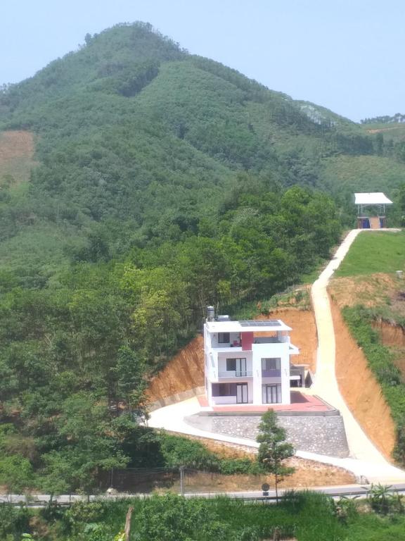 a house in the middle of a mountain at Mountain Breath Retreat - Am Nui Tho in Yen Bai
