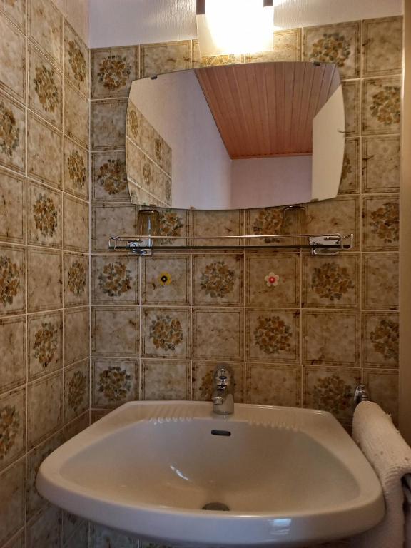 a bathroom with a sink and a mirror at Appartements direkt am See in Grundlsee