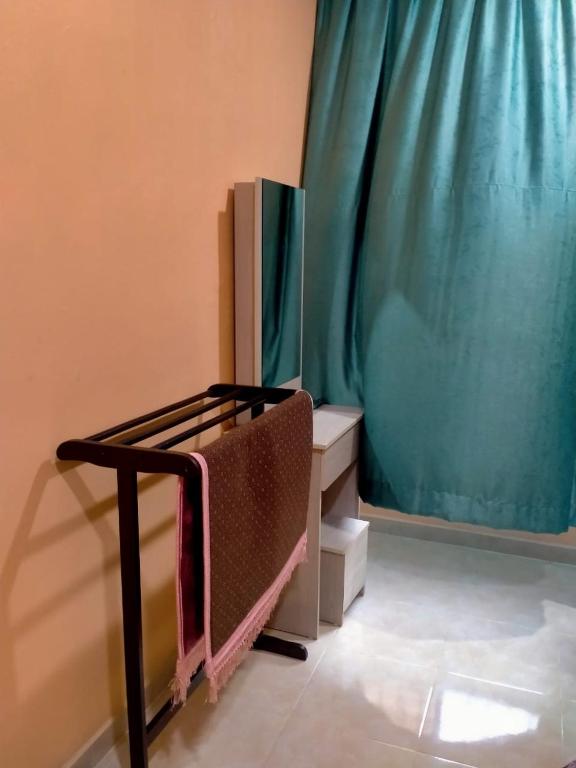 Postel nebo postele na pokoji v ubytování Rahman Homestay Pantai Johor - ISLAM SAHAJA