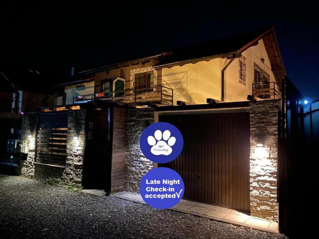 a sign in front of a building with a dog paw sign at IGI HOUSE with pool 12 km from Cluj-Napoca in Gilău