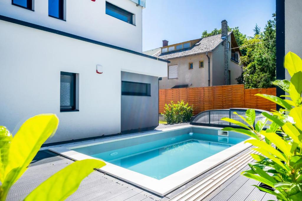 a swimming pool on the balcony of a house at MyFlat Villa Nuvola in Siófok