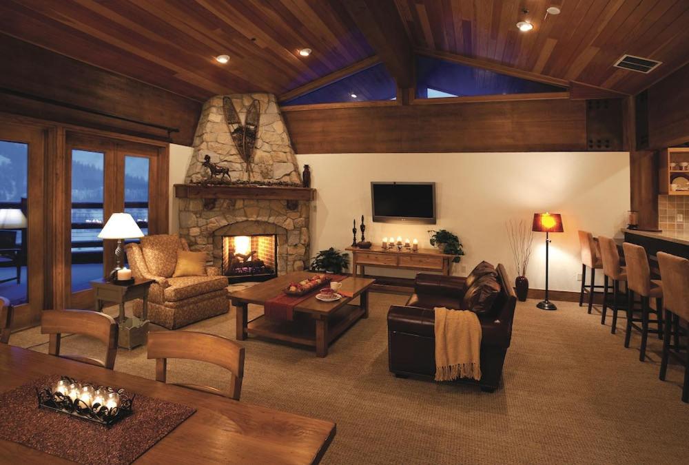 a living room with a fireplace and a couch and a table at Flagstaff Three Bedroom Suite with Majestic Mountain Views condo in Park City