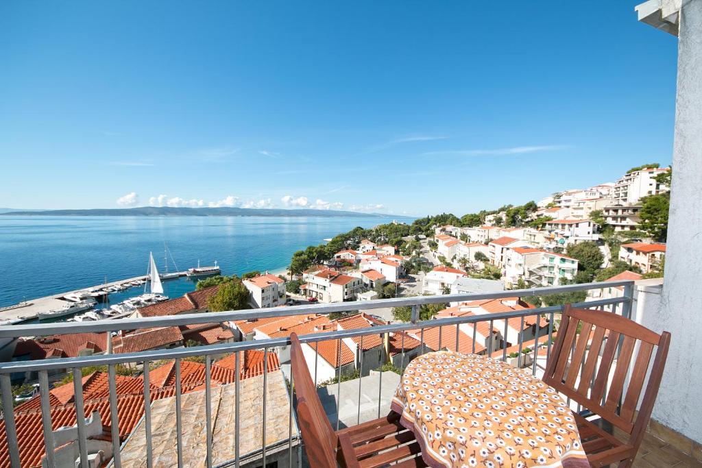 a balcony with a table and a view of the water at House Ursić in Brela