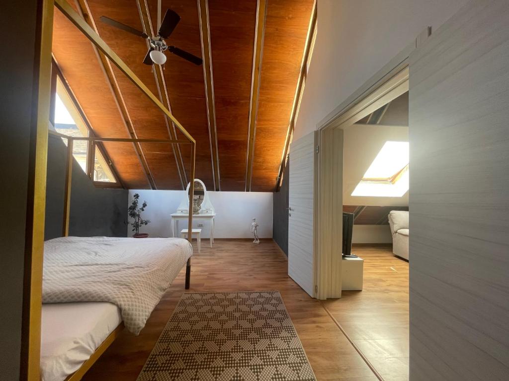 a bedroom with a bed and a ceiling fan at Amazing Savoya nr1 Loft Old City Center Self check-in in Timişoara