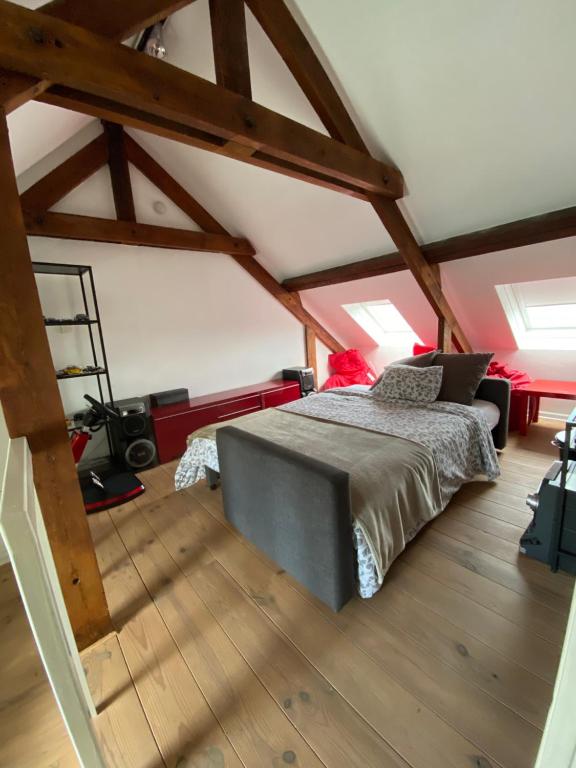 a bedroom with a bed in a attic at Hasselt City Garden Duplex in Hasselt