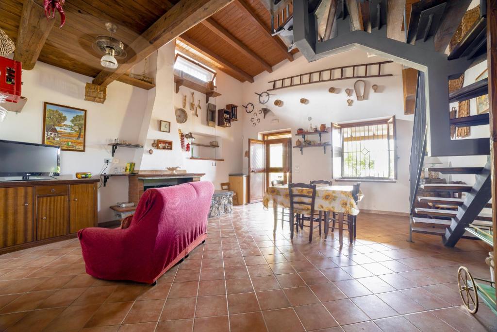 a kitchen and dining room with a table and chairs at Il Prato degli Ulivi in Rocca Imperiale