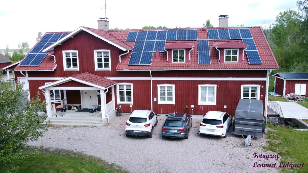 een rood huis met zonnepanelen op het dak bij Solmyra 56 Gästhem in Solmyra