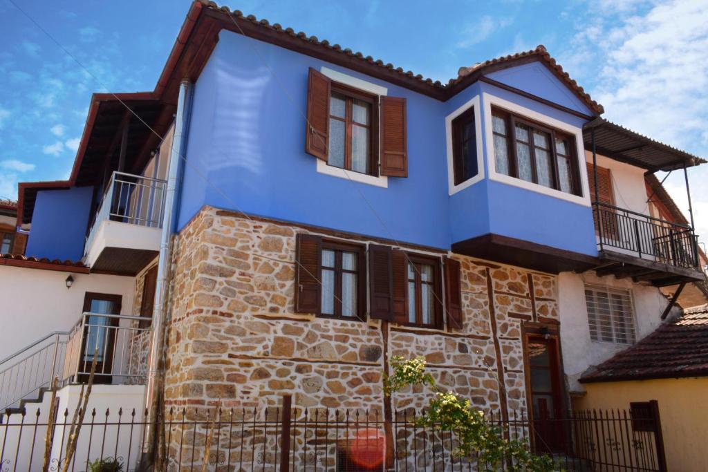 a house with blue paint on it at Renovated Old Manor House With Yard in Arnaia