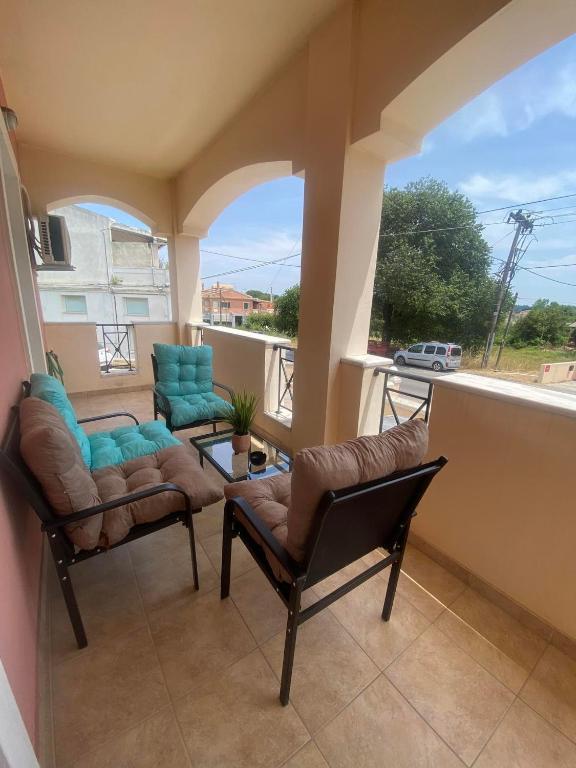 a balcony with two chairs and a table at dimitris house 2 in Alepou