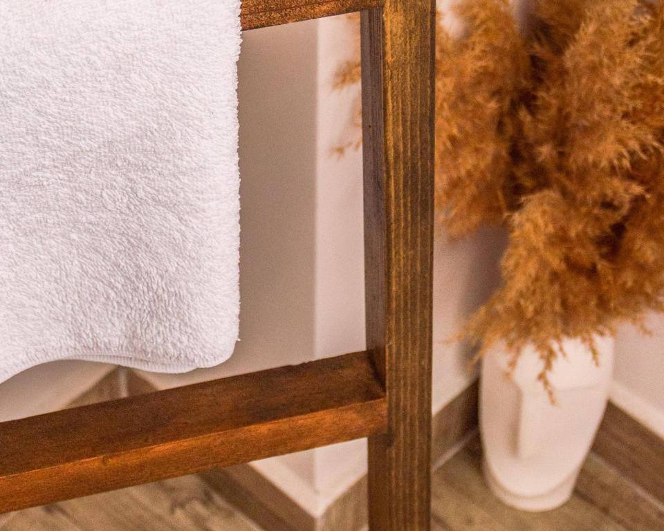a wooden shelf with a towel and a vase at Kaş Old Town Hotel in Kaş