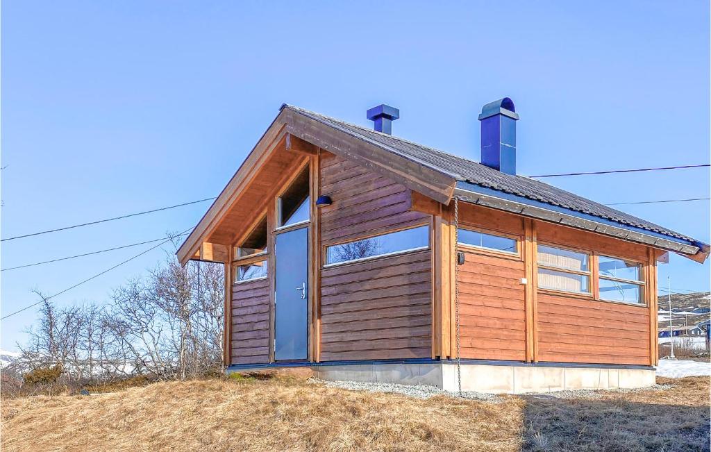 a small wooden house on top of a hill at Gorgeous Home In Geilo With House A Mountain View in Geilo