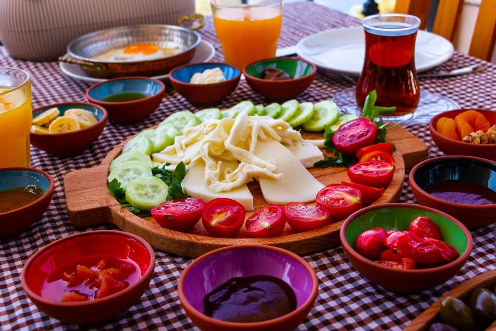 a table with plates of food and bowls of vegetables at Kaş Old Town Hotel in Kaş