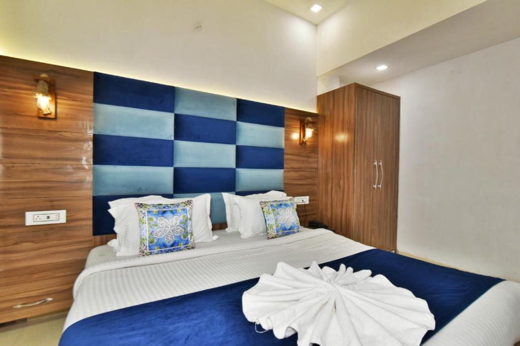 a bedroom with a blue and white striped wall at Hotel sallow International-Hotel Near Golden Temple in Amritsar
