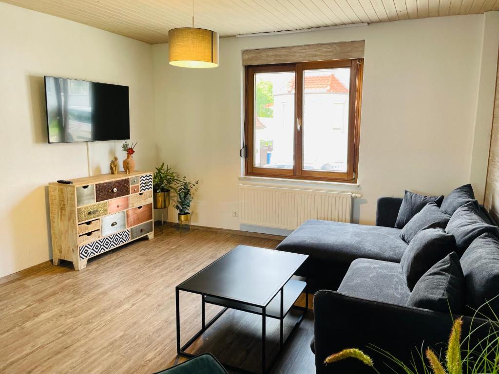 a living room with a couch and a table at Zollernalb-Apartment PR in Albstadt