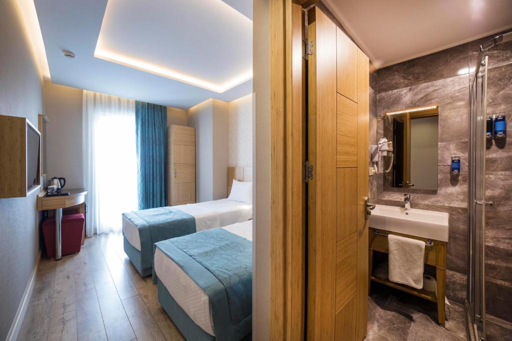 Postel nebo postele na pokoji v ubytování Meretto Hotel LALELİ