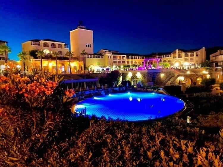 a large blue swimming pool in front of a building at L&#39;écrin du Cap Esterel in Saint-Raphaël