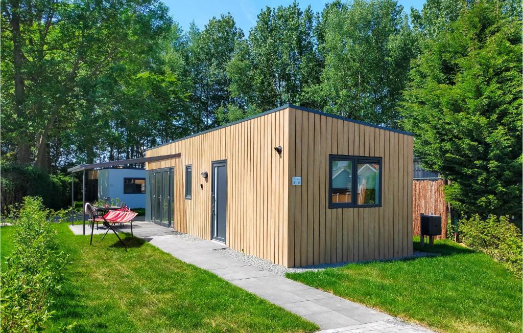 a small wooden building in a yard at Cozy Home In Heinkenszand With Kitchen in Heinkensand