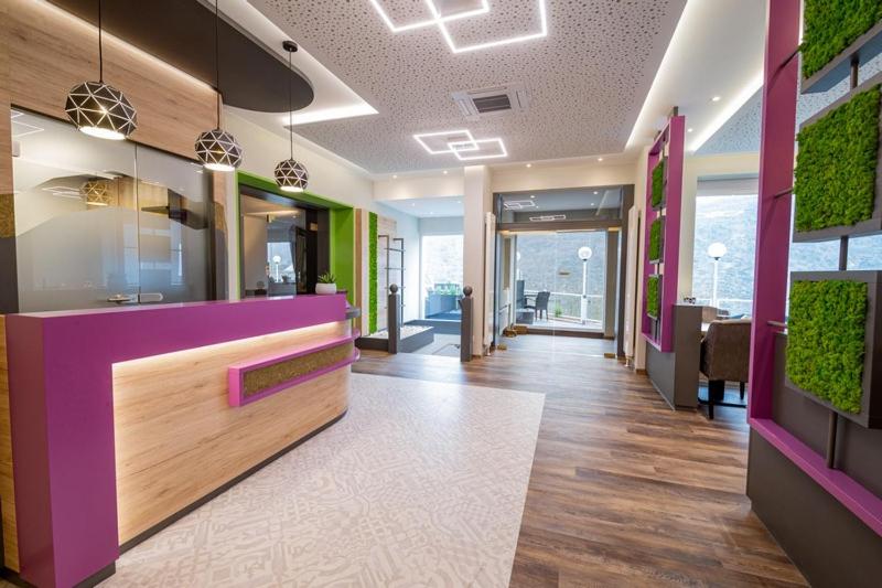 an office lobby with a pink and purple counter at Hotel Hegenbarths in Cochem