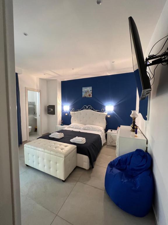 a bedroom with a large bed and a blue wall at Samcri Luxury Home in Catania