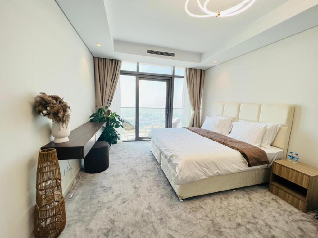 Paramount midtown residence luxury 3 bedroom with amazing sea view and close to burj khalifa and dubai mall في دبي: غرفة نوم بسرير كبير ونافذة كبيرة