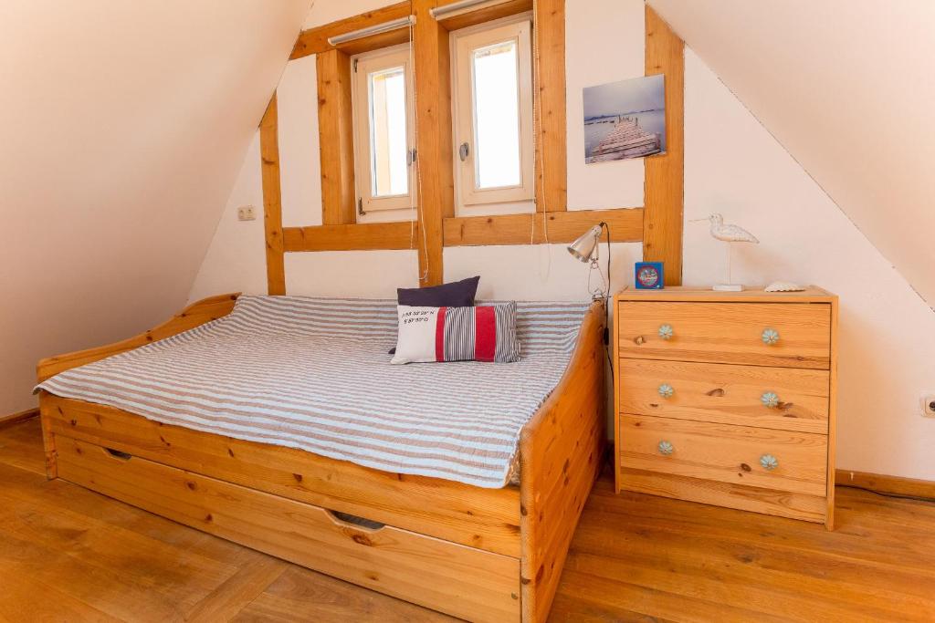 a bedroom with a wooden bed and a dresser at Maisonette Baugut in Remlingen