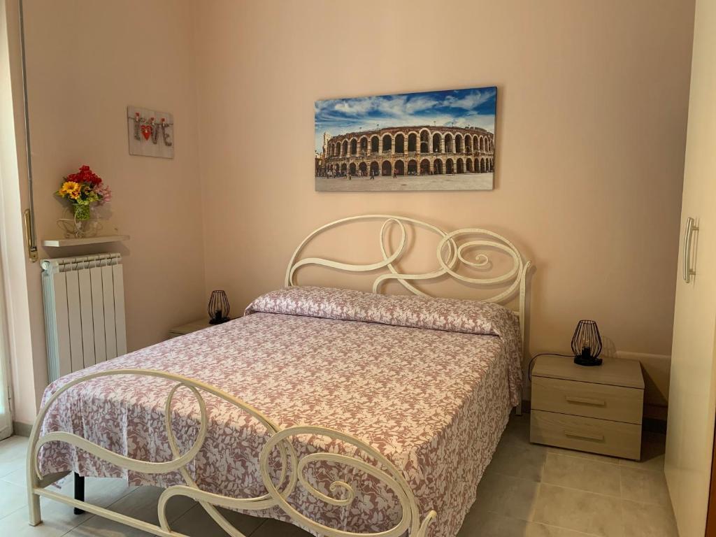 - une chambre avec un lit et une photo du Colisée dans l'établissement La Casetta, à Vérone