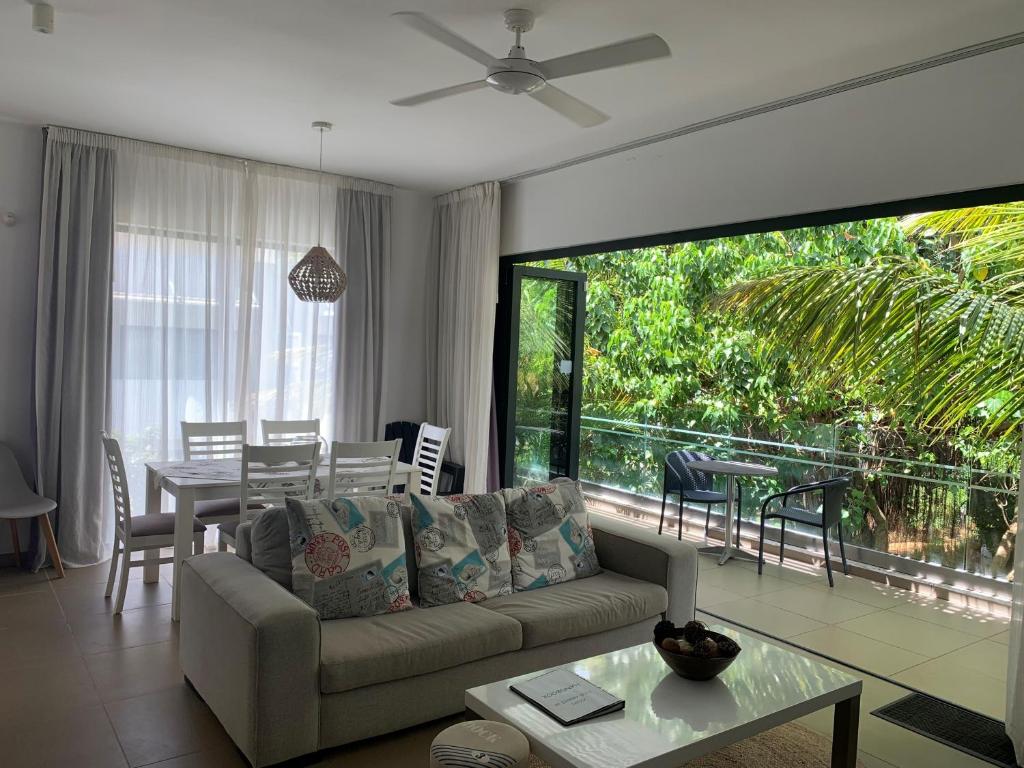 a living room with a couch and a table at Azuri Apartment 8 in Roches Noires