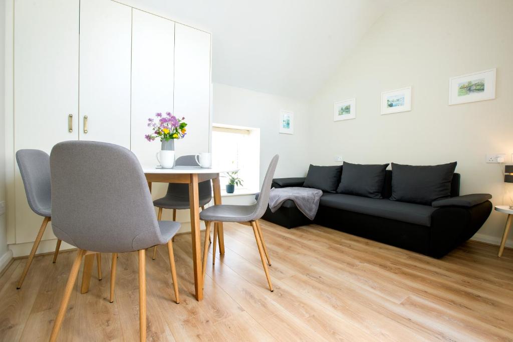 a living room with a table and a couch at Sallins Loft in Sallins