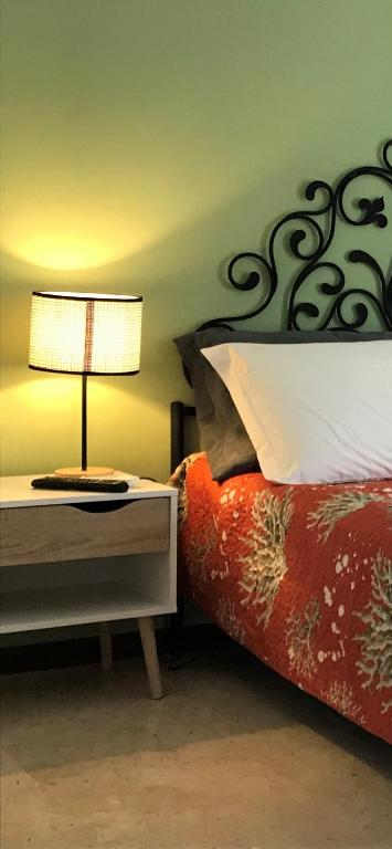 a bedroom with a bed with a lamp on a table at B&B Ospedale Maggiore Parma affittacamere in Parma