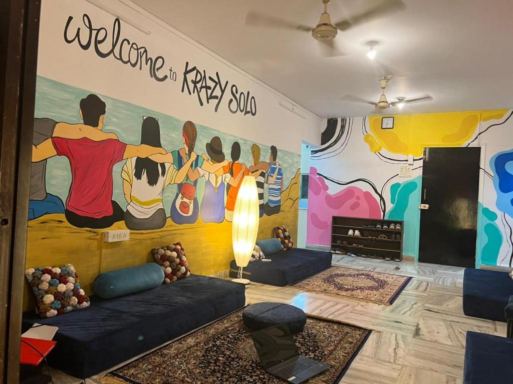 a room with a mural on the wall at Krazy Solo Hostel in Mumbai