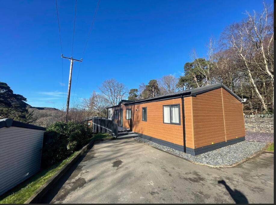 a tiny house sitting on top of a driveway at C05 - The Ogwen Lodge with Hot Tub in Bethesda