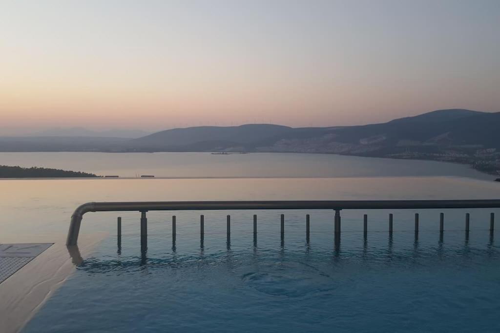 a swimming pool with a view of a body of water at Dilbar Villa in Akbük